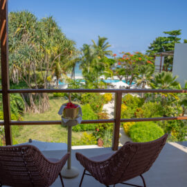 Aerial view of the lush tropical gardens, swimming pool, and beachfront area at Alma Boutique Hotel in Zanzibar, offering a serene getaway.