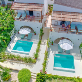 Aerial view of the lush tropical gardens, swimming pool, and beachfront area at Alma Boutique Hotel in Zanzibar, offering a serene getaway.